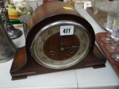 An oak cased dome top mantel clock