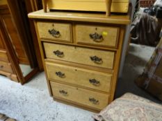 A lightwood narrow chest of drawers, two short above three long