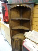 An Old Charm dark oak standing corner cupboard, shelves above a cupboard base