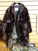 A green ladies wax jacket together with a fur coat