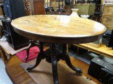 An oval inlaid & marquetry tilt-top table on a heavy footed base