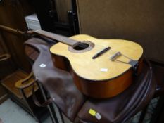 A vintage cased acoustic guitar