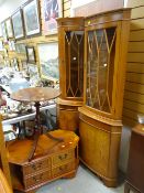 A large parcel of reproduction yew furniture items including corner cupboard, narrow bookcase,