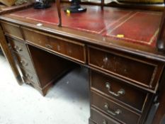Reproduction mahogany kneehole desk with red leather tooled top