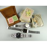 A box containing two Seiko gents stainless steel watches together with playing cards (boxed &