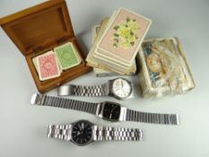 A box containing two Seiko gents stainless steel watches together with playing cards (boxed &