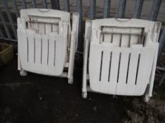 A pair of white plastic garden sun loungers (outside)