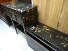 A pair of modern black floral painted bedside cabinets together with a similar matching lidded