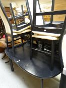 A modern black ash extending dining table together with four matching high back chairs