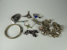 Small box containing a silver Art Nouveau brooch, a heavy silver charm bracelet with numerous charms