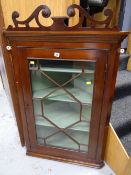 A good antique mahogany astragal glazed hanging corner cupboard with painted interior