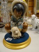 A Lladro figure of an eskimo child on plinth