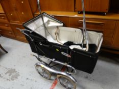 A large black vintage Marmet coach-style pram with chrome wire wheels, circa 1960s