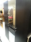 A modern black ash wardrobe with centre mirror together with a white chest of drawers