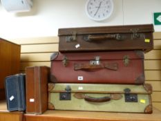 Five vintage suitcases of various sizes