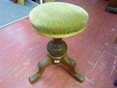 Green upholstered tripod piano stool with carved detail