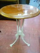Ornate metal base table with circular wooden top
