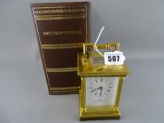 Swiss made brass cased carriage clock for Matthew Norman, retailer, with visible escapement and with