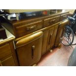 Oak railback sideboard with carved centre drawer over three door base