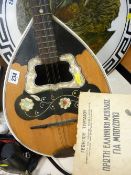Old mandolin with mother of pearl decoration and a small parcel of paperwork