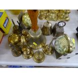Collection of brass bells, pair of globe bookends and a vintage brass weight