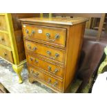 Small four drawer mahogany inlaid chest