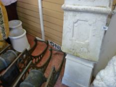 Two square chimney style garden ornaments and another pair of circular chimney pots