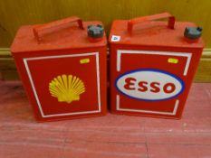 Red painted metal Esso petrol can and a red painted metal Shell petrol can