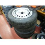 Parcel of four Ford 15 ins steel rims with tyres, sizes 195/65R1591T and Ford emblem hubcaps with