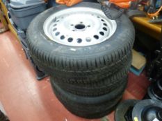 Parcel of four Ford 15 ins steel rims with tyres, sizes 195/65R1591T and Ford emblem hubcaps with