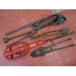 Parcel of heavy metal equipment, large metal chain wrench, bolt cutters and red car mechanic's