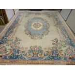 A CHINESE WASHED WOOLLEN CARPET, predominantly cream ground with multiple floral pattern, 376 x