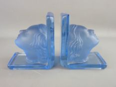 A PAIR OF ART DECO BLUE FROSTED & CLEAR GLASS HEAD BOOKENDS, 13 cms high (one chip to base)