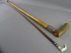 AN IVORY TOPPED RIDING CROP and a horn handled walking stick with wide silver collar, 94 and 89