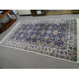 A PERSIAN STYLE 100% WOOL HAND KNOTTED CARPET, cream and blue ground with central repeating