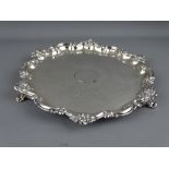 A SILVER THREE FOOTED SALVER with floral edge decoration, Sheffield 1869, 15.1 troy ozs, 26.5 cms