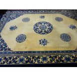 A LARGE BLUE & CREAM WASHED WOOLLEN CHINESE CARPET with tasselled ends, 375 x 276 cms