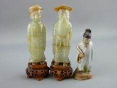 TWO CHINESE CARVED HARDSTONE FIGURES on wooden stands, 9 cms high and a pottery model of a deity,