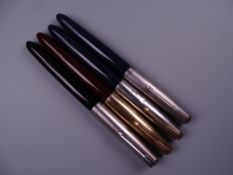 Four Vintage Parker 51 fountain pens (one black, two blue, one brown)