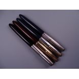 Four Vintage Parker 51 fountain pens (one black, two blue, one brown)