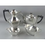 A FOUR PIECE SILVER TEA & COFFEE SERVICE, each piece of oblong plain panelled form, 42 ozs gross,