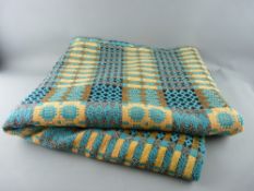 A TRADITIONAL WELSH WOOLLEN BLANKET in turquoise, orange and black tones (edge repairs and further