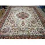 A GOOD EASTERN WOOLLEN CARPET with central medallion on a cream ground, repeating tree pattern and