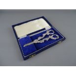 A CASED SET OF UNMARKED WHITE METAL GRAPE SCISSORS