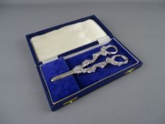 A CASED SET OF UNMARKED WHITE METAL GRAPE SCISSORS