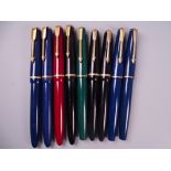 Four Vintage Parker Slimfold fountain pens (one black, two blue, one red), black cap damaged, all