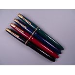 Four Vintage Parker Slimfold fountain pens (black, blue green, red), all with 14k nibs