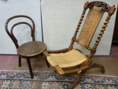 A VICTORIAN CARVED WALNUT FOLDING CHAIR and a child's bentwood chair, 75 and 61 cms high