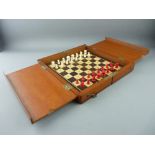 A CIRCA 1900 MAHOGANY CASED TRAVEL CHESS SET, the pieces in turned and stained bone on a boxwood and