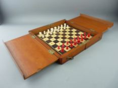 A CIRCA 1900 MAHOGANY CASED TRAVEL CHESS SET, the pieces in turned and stained bone on a boxwood and